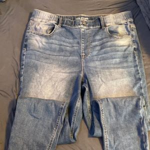 Blue jeans with a white washed finish, ankle length